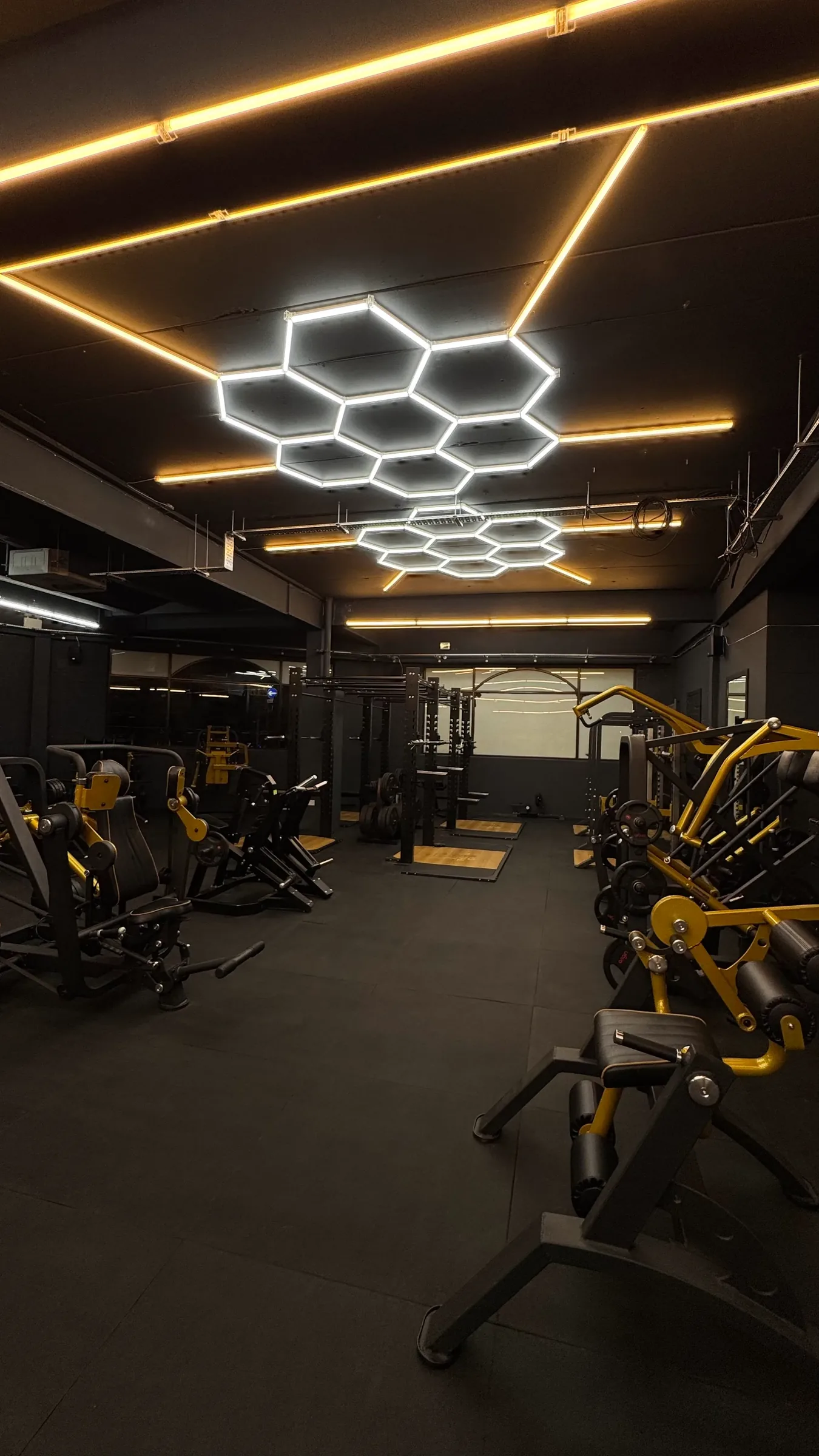 Atmospheric honeycomb LED lighting over the training floor at The Rig Gym